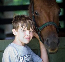 Hanging out with the horses is one of the highlights of this camper's summer.