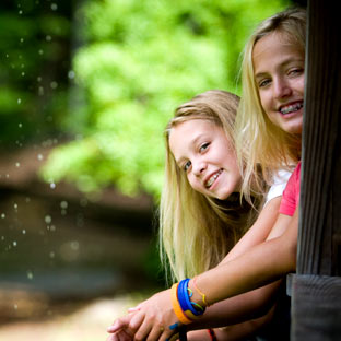 Two smiling girls at an overnight summer camp